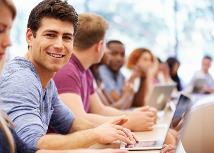 Class Of University Students Using Laptops In Lecture