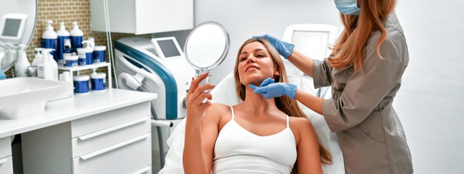Cosmetologist,Is,Consulting,Woman,Client,Who,Looking,At,Mirror,In